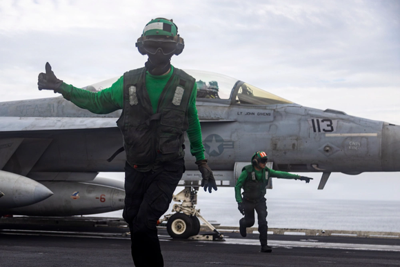 U.S. Sailors conduct final checks on an F/A-18F Super Hornet, attached to Strike Fighter Squadron (VFA) 41, as it prepares to launch from the flight deck of Nimitz-class aircraft carrier USS Abraham Lincoln (CVN 72), Operation Epic Fury, March 23, 2026