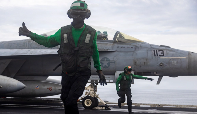 U.S. Sailors conduct final checks on an F/A-18F Super Hornet, attached to Strike Fighter Squadron (VFA) 41, as it prepares to launch from the flight deck of Nimitz-class aircraft carrier USS Abraham Lincoln (CVN 72), Operation Epic Fury, March 23, 2026