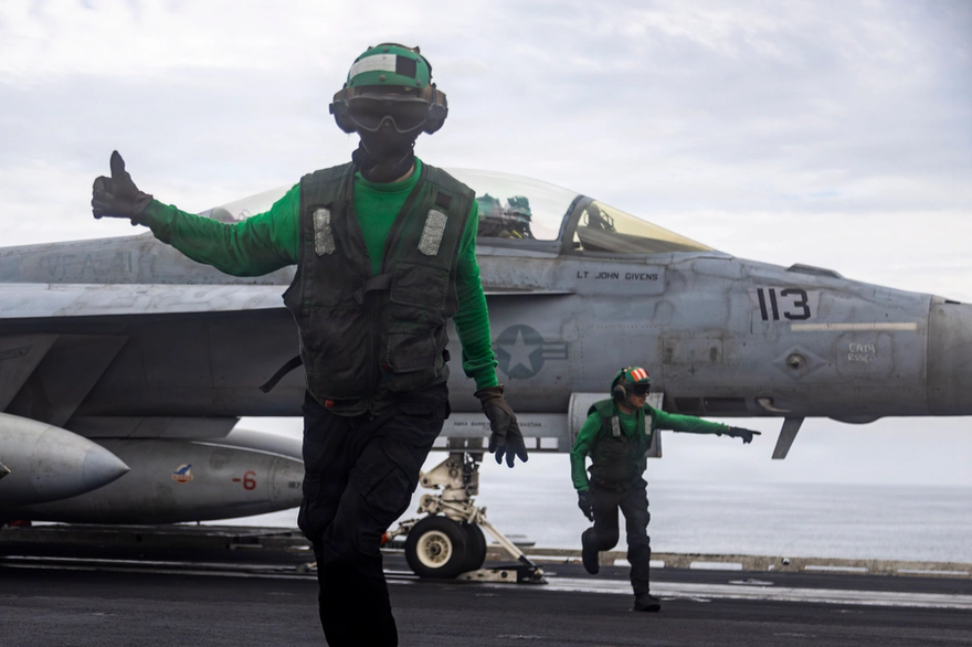 U.S. Sailors conduct final checks on an F/A-18F Super Hornet, attached to Strike Fighter Squadron (VFA) 41, as it prepares to launch from the flight deck of Nimitz-class aircraft carrier USS Abraham Lincoln (CVN 72), Operation Epic Fury, March 23, 2026
