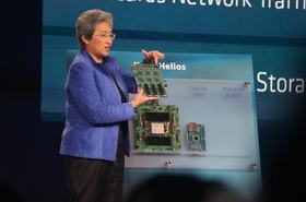 Dr Lisa Su holding up the 'Vulcano' AMD Pensando AI NIC at Advancing AI 2026
