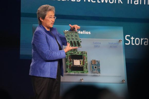 Dr Lisa Su holding up the 'Vulcano' AMD Pensando AI NIC at Advancing AI 2026
