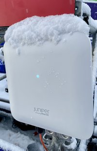 A HPE AP63 outdoor Wi-Fi Access Point covered in snow