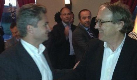 Michel Emelianoff (L) and David Winn shake hands on the landmark partnership contract