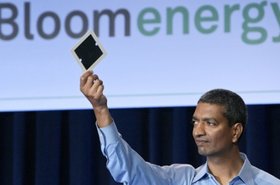 Bloom Energy CEO and co-founder KR Sridhar holding up a Bloom fuel cell