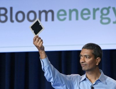 Bloom Energy CEO and co-founder KR Sridhar holding up a Bloom fuel cell