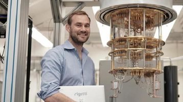 Chad Rigetti near one of his quantum computers .jpg