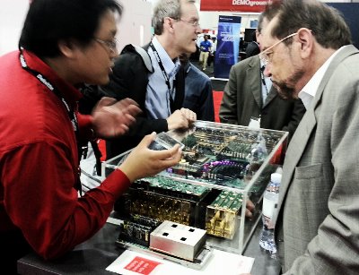 Fujitsu engineer James Li (left) shows an Oracle OpenWorld 2012 attendee the Fujitsu prototype server built on its latest Sparc 64-X CPUs and one of the chips