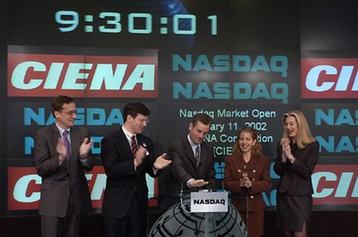Gary Smith, Ciena CEO (center) and team ringing the opening bell at the NASDAQ stock exchange on January 11, 2002