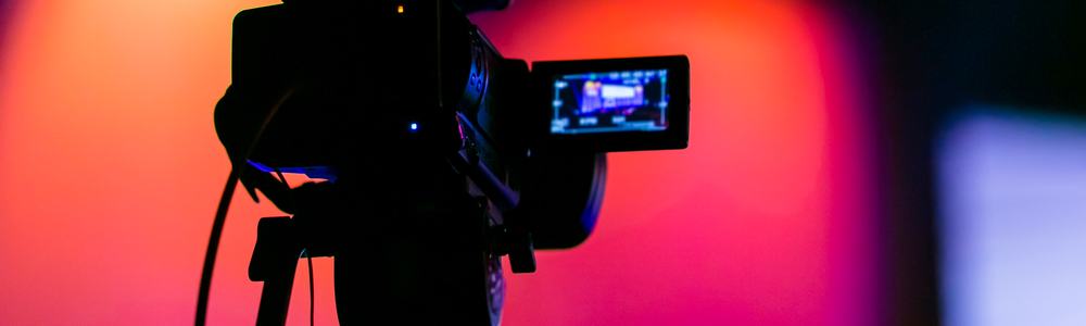 Silhouette of a TV Camera filming a live broadcast