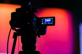Silhouette of a TV Camera filming a live broadcast