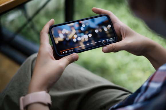 Person watching live stream on smartphone