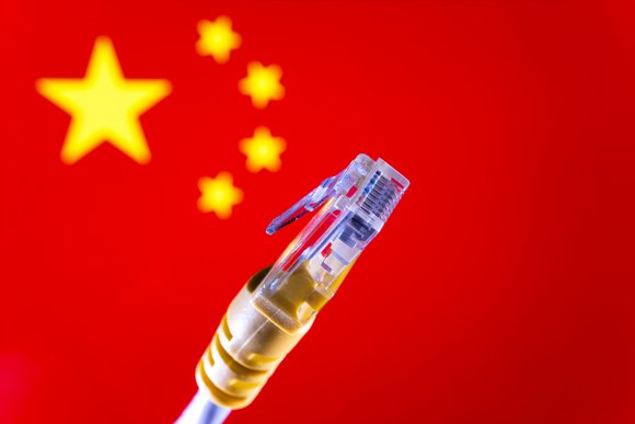 Ethernet cable connector and blurred Chinese flag on the background