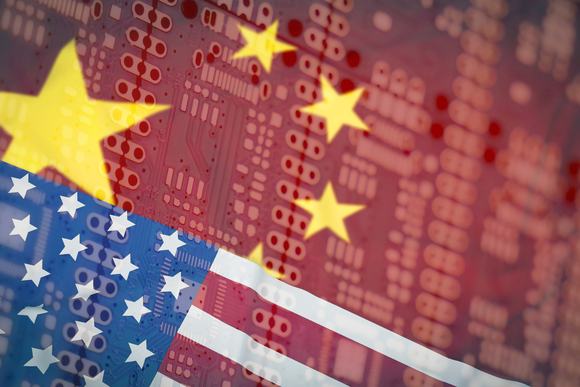 US and Chinese flags superimposed on a PCB board