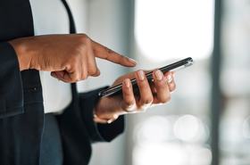 Closeup of a person's hands typing on a phone