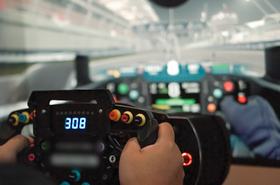Close up of gamer playing car racing video game