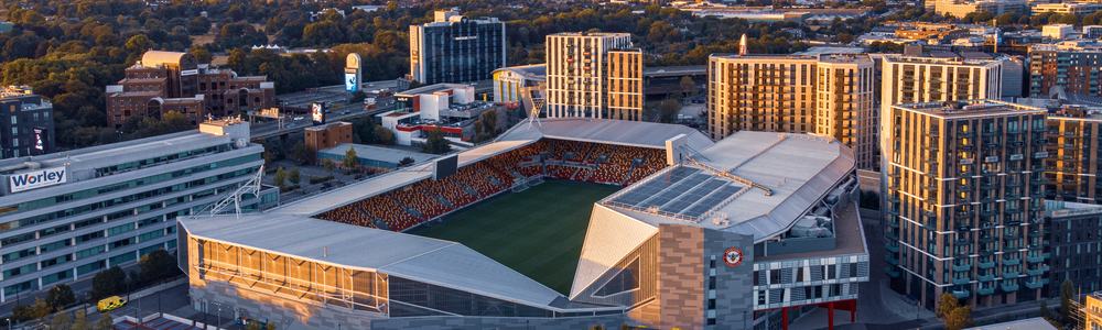 Aerial view of Gtech Community Stadium at sunset.