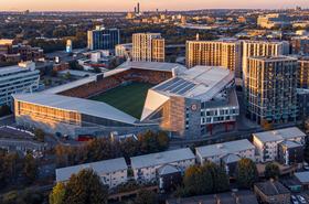 Aerial view of Gtech Community Stadium at sunset.