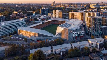 Aerial view of Gtech Community Stadium at sunset.