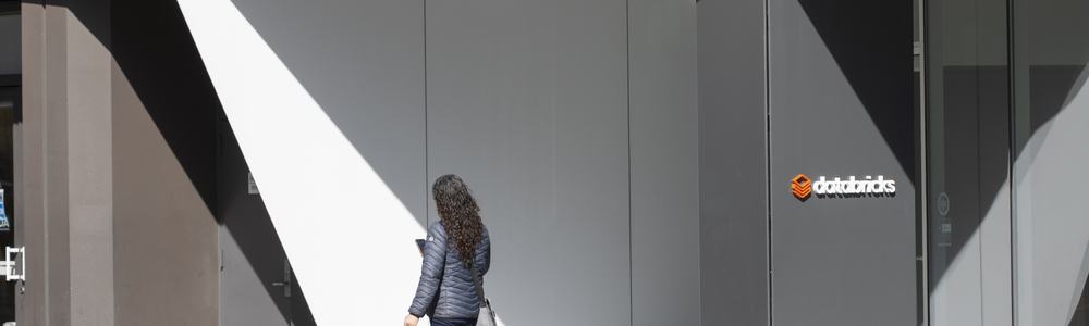 A woman walks past the entrance to the headquarters of Databricks