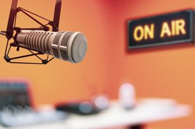 Professional podcasting studio with a microphone and on air sign