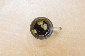 A mug of coffee with mould in it