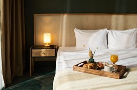 Breakfast Tray on Bed with Elegant Setup in Hotel Room