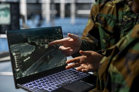 Close up of army experts in data center analyzing infrared surveillance feed