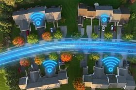 Aerial top-down view of American homes with glowing fiber optic lines and Wi-Fi symbols showing high-speed internet