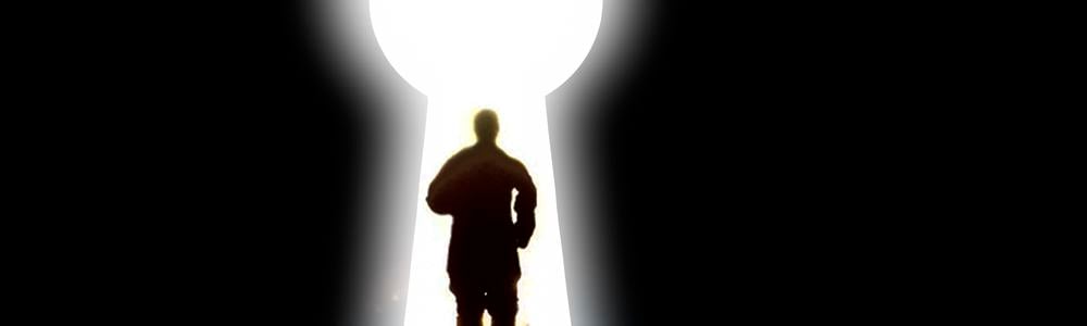 Silhouette of a man running through a keyhole