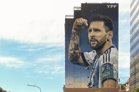 Street art mural by Martin Ron featuring Lionel Messi famous football player in national team jersey