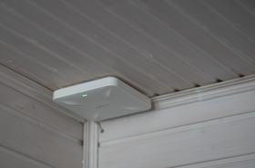 A wireless access point on ceiling in indoor space