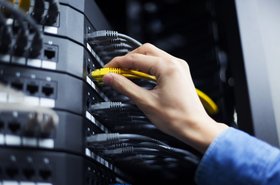Hand with network cable in a data center