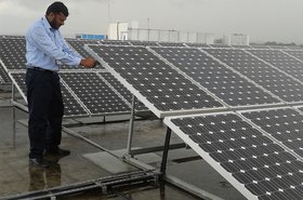 A technician inspects IBM's solar power array (2011)