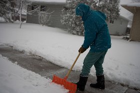 A North Dakota resident shovelling snow