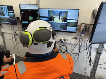 An engineer remote piloting a construction vehicle at OuluZone