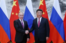 Russia's Putin and China's Xi Jinping shake hands
