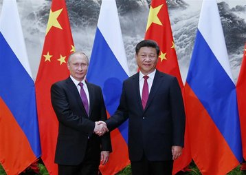 Russia's Putin and China's Xi Jinping shake hands