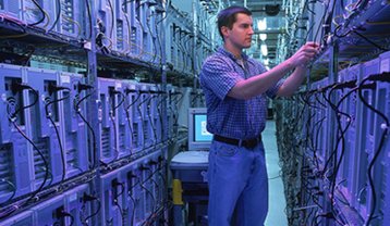 A Rackspace tech in an aisle of one of the hosting company's data centers