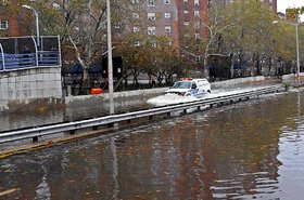 NYPD car driving through East Village, flooded by Hurricane Sandy. By David Shankbone