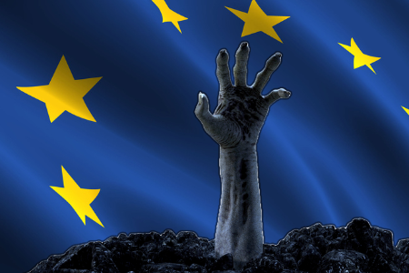 Zombie hand reaching out from the grave superimposed in front of the EU flag