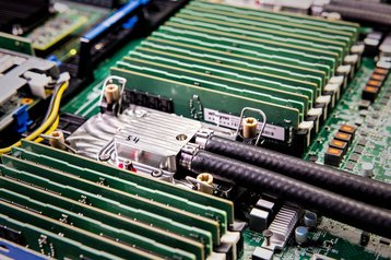 A microfluidics chip developed by Microsoft is covered and has tubing attached so the coolant can flow safely