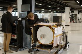 Technicians perform environmental testing on the Polylingual Experimental Terminal (PExT) in preparation for launch