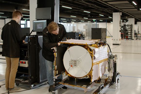 Technicians perform environmental testing on the Polylingual Experimental Terminal (PExT) in preparation for launch