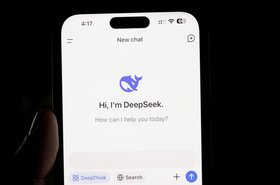 A person holding a phone displaying the DeepSeek app