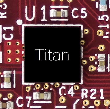 "Photograph of Titan up-close on a printed circuit board. Chip markings obscured"